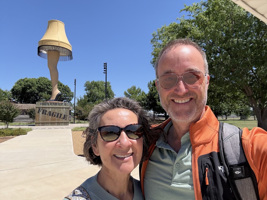 Peter and his wife taking a selfie in front of the giant leg lamp in Chickasha, Oklahoma