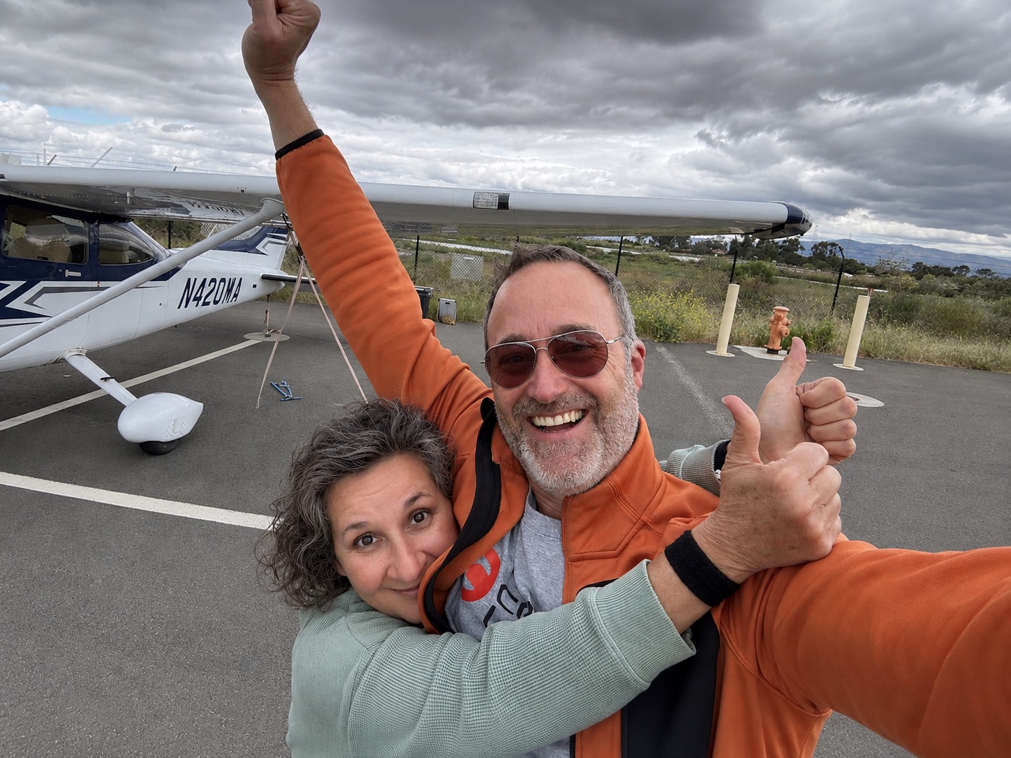 Peter and his wife celebrating next to their Cessna 182 after landing back at Palo Alto