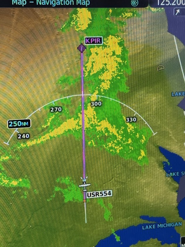 G1000 map showing green and yellow NEXRAD weather along the route to Pierre, South Dakota (KPIR)